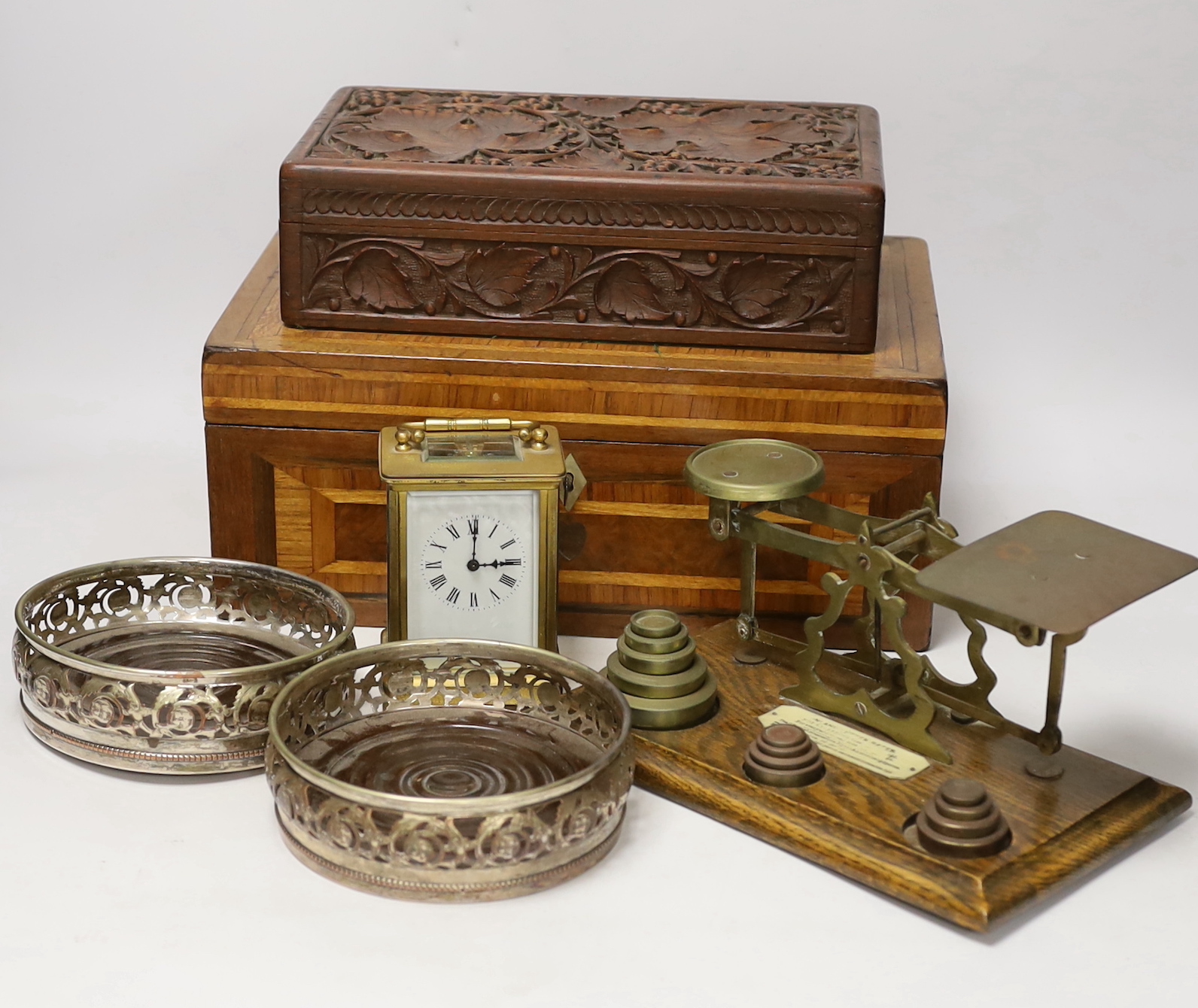 Letter scales and weights, a inlaid box, a carved box, a pair of plated coasters, carriage clock, inlaid box 33cm wide x 13cm high